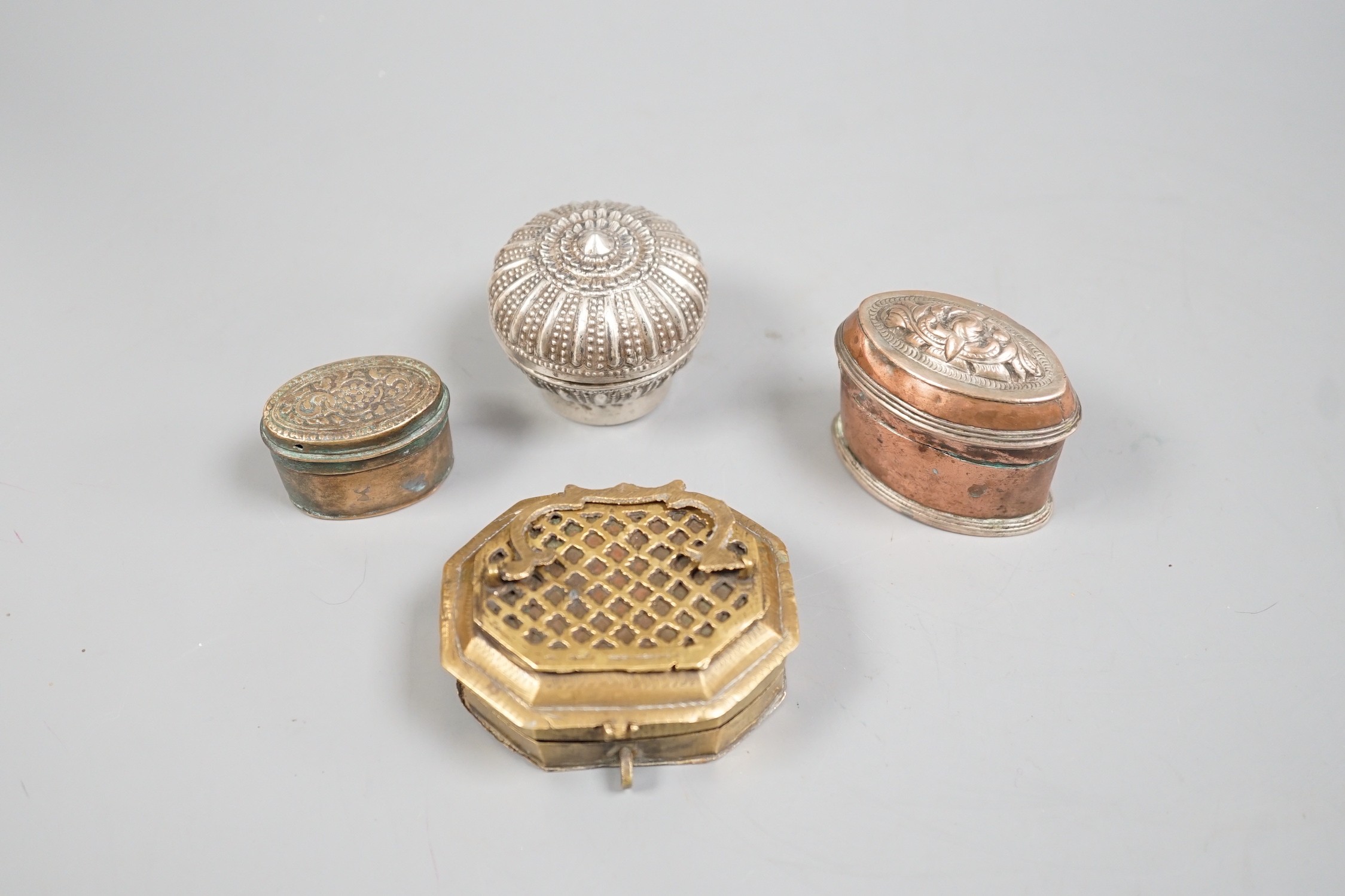 Four southeast Asian metal Betel nut containers, largest 7.5 cm